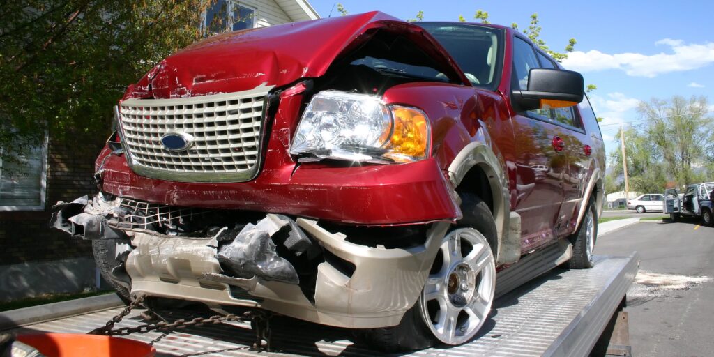 Auction car shipping canada. A salvage car loaded onto a trailer