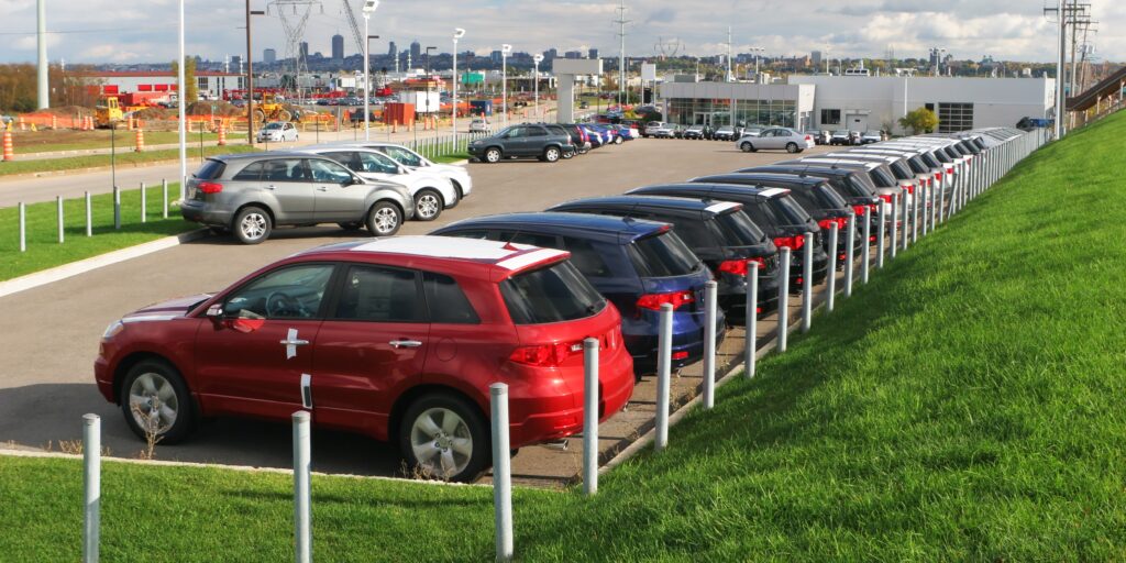 Auction vehicle transport in Canada showing a dealership lot.